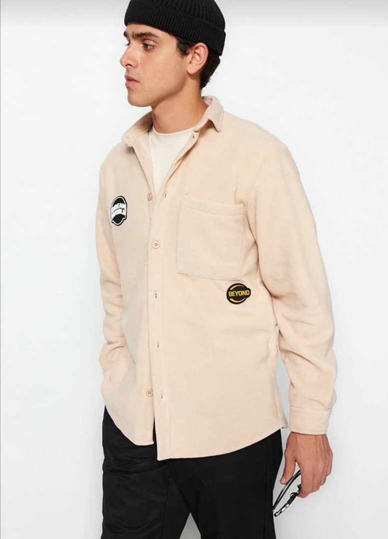 beige labeled shirt